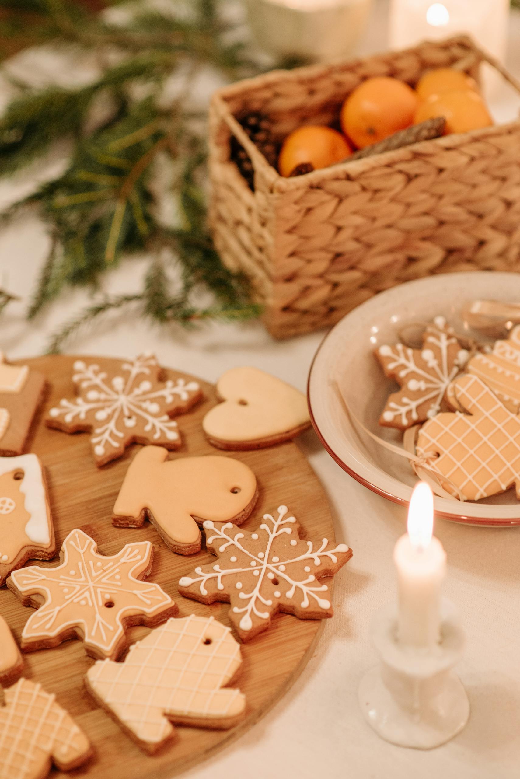 Homemade holiday cookies beautifully arranged with festive decorations and candlelight.